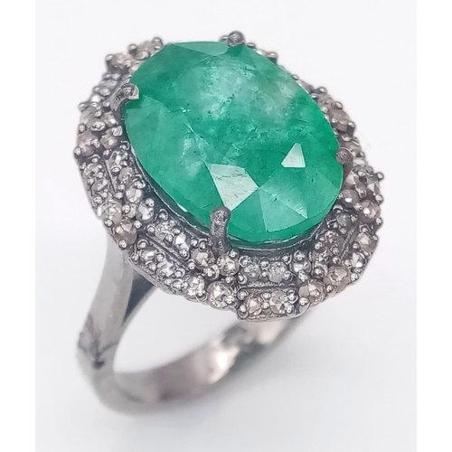 863 - An 8ct Oval Cut Emerald Ring with 0.75ctw of Twin Diamond Halos - Set in 925 Silver. Size N. 6.4g we... 