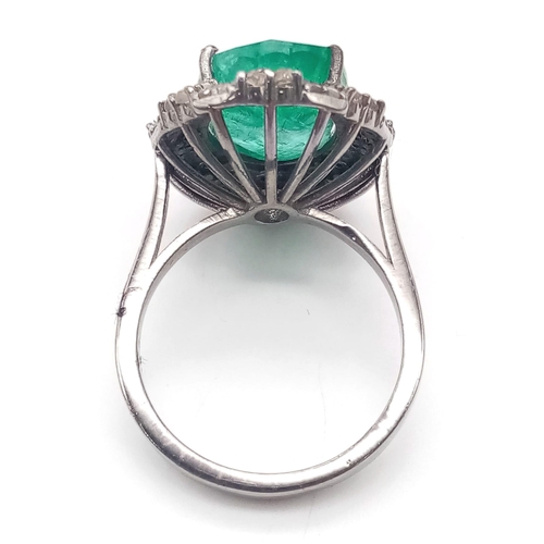 863 - An 8ct Oval Cut Emerald Ring with 0.75ctw of Twin Diamond Halos - Set in 925 Silver. Size N. 6.4g we... 