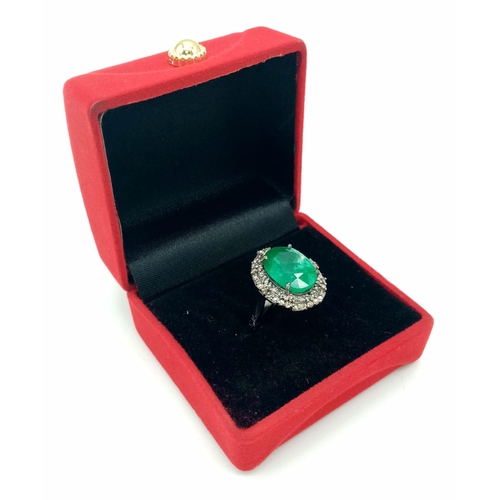 863 - An 8ct Oval Cut Emerald Ring with 0.75ctw of Twin Diamond Halos - Set in 925 Silver. Size N. 6.4g we... 