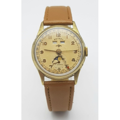 1080 - A VINTAGE ROTARY MOONPHASE WATCH WITH DATE BOX ON A BROWN LEATHER STRAP .  33mm