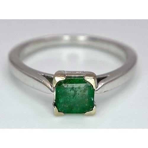 1186 - AN 18K WHITE GOLD RING WITH SQUARE EMERALD CENTRE STONE .   3.3gms   size N