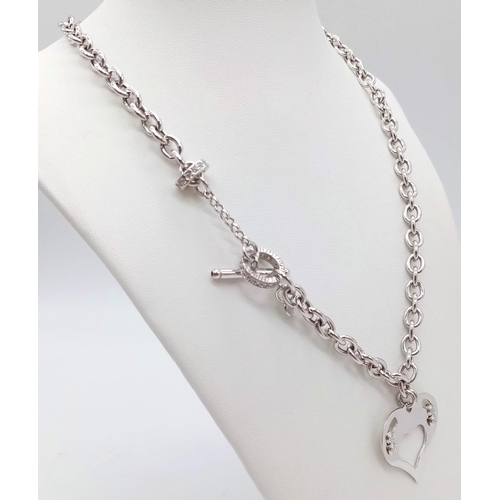 1201 - A SILVER STONE SET NECKLACE WITH HEART PENDANT AND T-BAR FASTENING .   22gms    42cms