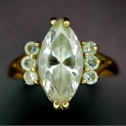 710 - A 14K GOLD RING WITH BOAT SHAPED ZIRCONIA CENTRE STONE AND 3 SUPPORTING STONES ON EITHER SIDE . 2.9g... 