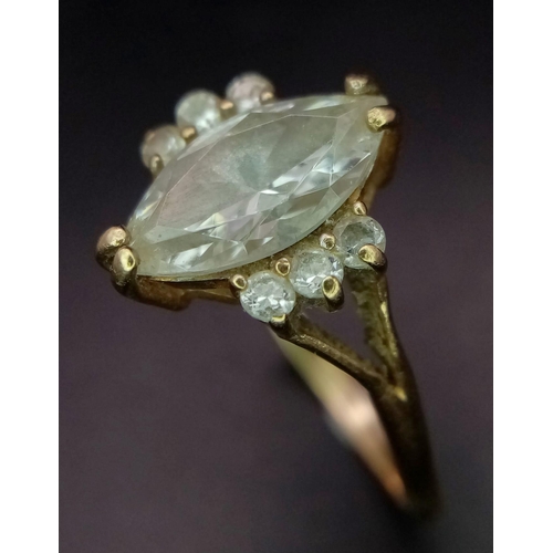 710 - A 14K GOLD RING WITH BOAT SHAPED ZIRCONIA CENTRE STONE AND 3 SUPPORTING STONES ON EITHER SIDE . 2.9g... 