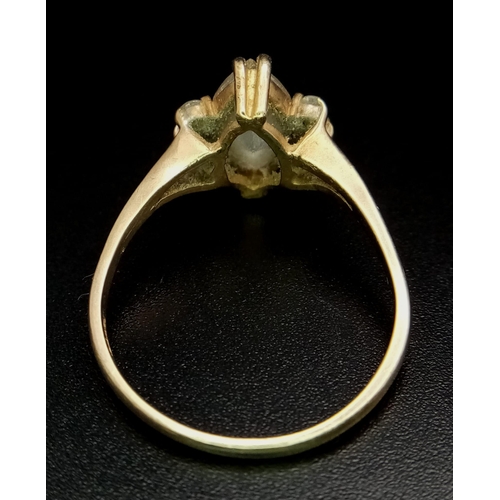 710 - A 14K GOLD RING WITH BOAT SHAPED ZIRCONIA CENTRE STONE AND 3 SUPPORTING STONES ON EITHER SIDE . 2.9g... 