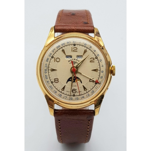 711 - A VINTAGE ROTARY MOONPHASE MID SIZE WATCH WITH DATE BOX AND ON A BROWN LEATHER STRAP .  34mm