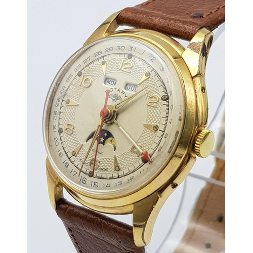 711 - A VINTAGE ROTARY MOONPHASE MID SIZE WATCH WITH DATE BOX AND ON A BROWN LEATHER STRAP .  34mm