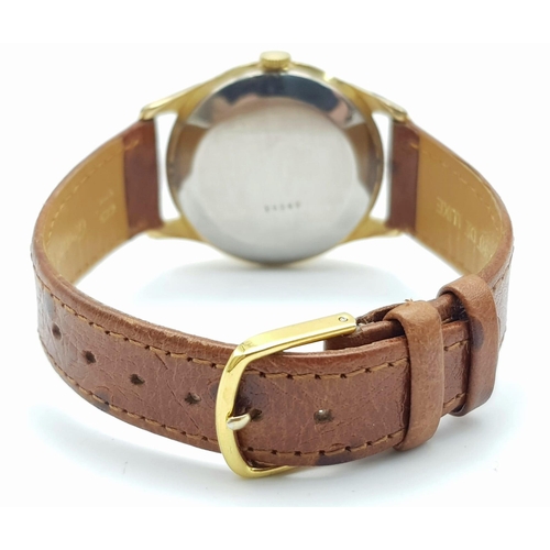 711 - A VINTAGE ROTARY MOONPHASE MID SIZE WATCH WITH DATE BOX AND ON A BROWN LEATHER STRAP .  34mm