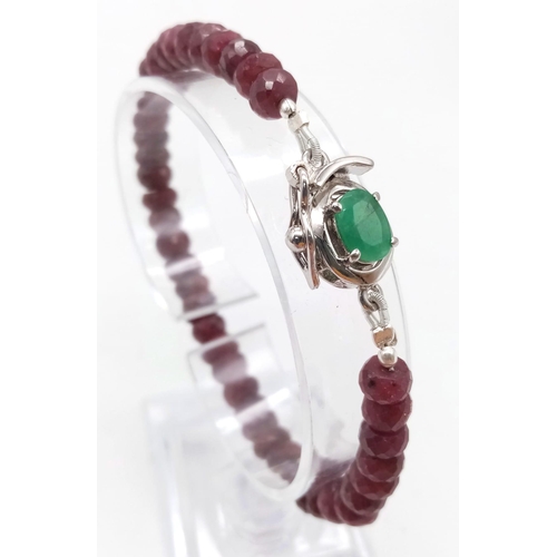 942 - A 100ctw Faceted Rondelle Ruby Gemstone Bracelet with Emerald Clasp. Set in 925 Silver. 19cm length.... 