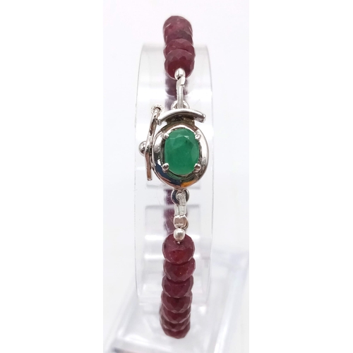 942 - A 100ctw Faceted Rondelle Ruby Gemstone Bracelet with Emerald Clasp. Set in 925 Silver. 19cm length.... 