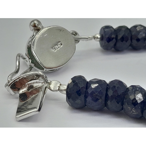 1331 - A 120ctw Faceted Rondelle Blue Sapphire Bracelet with Emerald Clasp, set in 925 Silver. 20cm. 23.75g... 