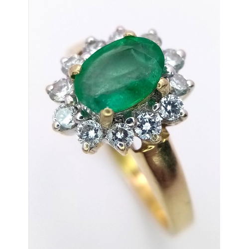 1685 - AN 18K GOLD RING WITH A 1ct EMERALD CENTRE STONE SURROUNDED BY BRIGHT DIAMONDS .   3.4gms   size O