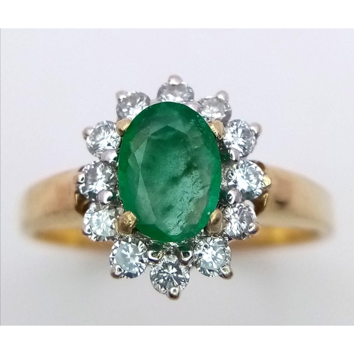 1685 - AN 18K GOLD RING WITH A 1ct EMERALD CENTRE STONE SURROUNDED BY BRIGHT DIAMONDS .   3.4gms   size O