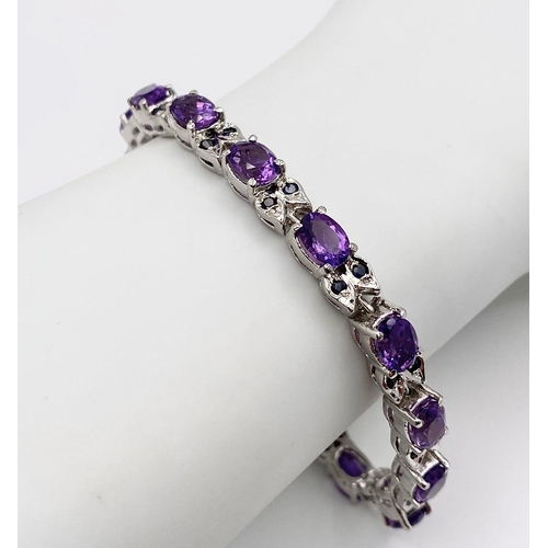 1245 - An Amethyst Gemstone Tennis Bracelet with Sapphire Spacers set in 925 Silver. 18cm length. 22.46g to... 