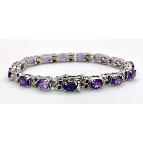 1245 - An Amethyst Gemstone Tennis Bracelet with Sapphire Spacers set in 925 Silver. 18cm length. 22.46g to... 