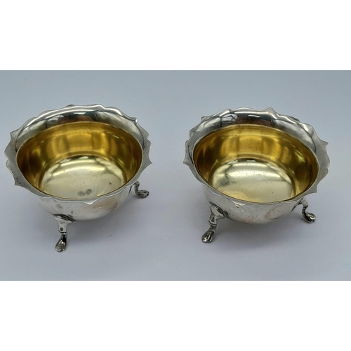 1481 - A PAIR OF FOOTED SILVER SALTS WITH GILDED INTERIOR DATED 1919 BIRMINGHAM .  46.2gms    6cms DIAMETER