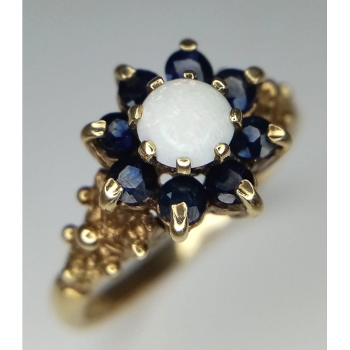 1657 - A Vintage 9K Yellow Gold Opal and Sapphire Ring. Central opal with a sapphire cluster. Size P. 3.08g... 