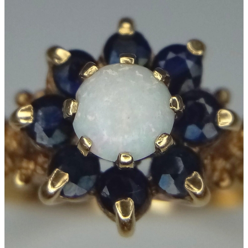 1657 - A Vintage 9K Yellow Gold Opal and Sapphire Ring. Central opal with a sapphire cluster. Size P. 3.08g... 