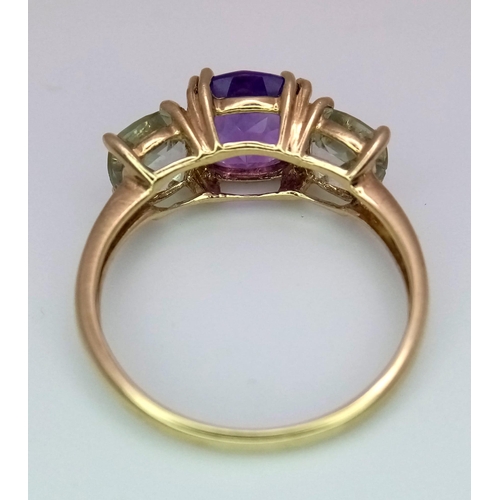 1340 - An Amethyst and Aquamarine 9K Yellow Gold Ring. Size P. 2.75g total weight.