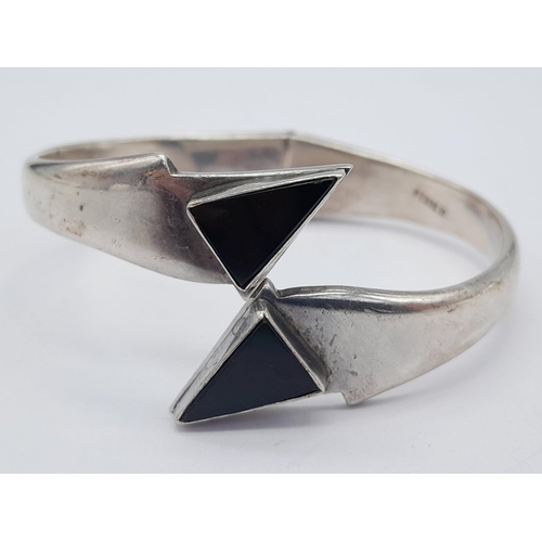 1502 - A VERY ATTRACTIVW SILVER HINGED BANGLE WITH BLACK ONYX ENDS  .   49gms