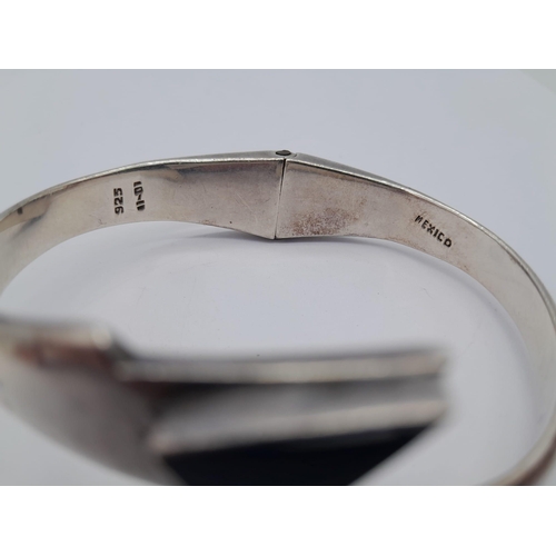 1502 - A VERY ATTRACTIVW SILVER HINGED BANGLE WITH BLACK ONYX ENDS  .   49gms