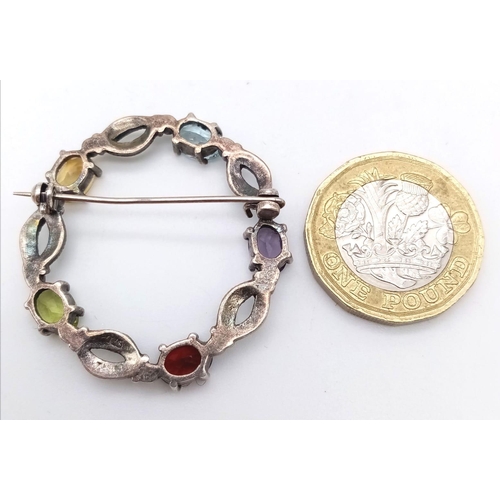 1509 - A VINTAGE SILVER GEMSTONE AND MARCASITE CIRCULAR BROOCH .   6gms