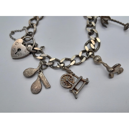 1516 - A SILVER CHARM BRACELET WITH 8 CHARMS .  30gms