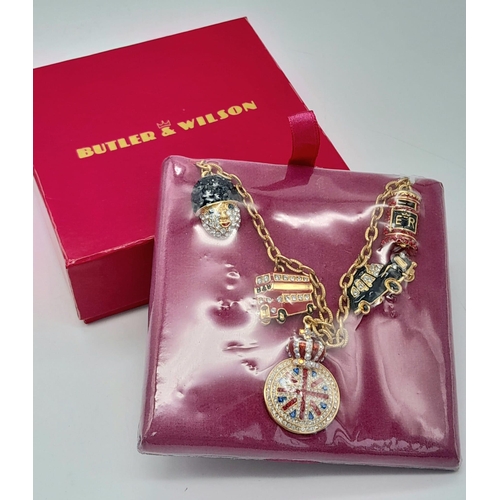 1553 - A Butler and Wilson London Charms Necklace. As new, in box.