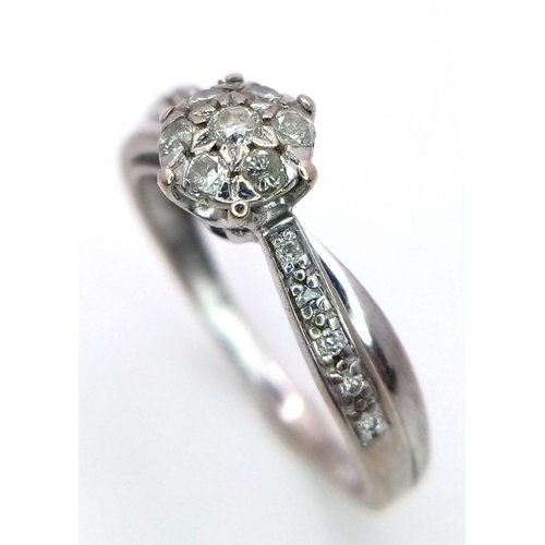 1636 - A 9K White Gold Diamond Cluster Ring. Size P. 2.45g total weight.