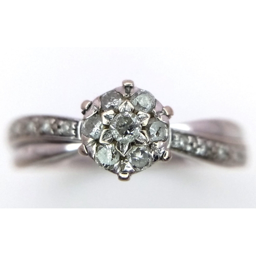 1636 - A 9K White Gold Diamond Cluster Ring. Size P. 2.45g total weight.