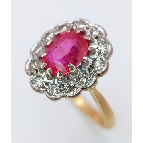 1650 - An 18K Yellow Gold, Burmese Ruby and Diamond Ring. 1ct central oval cut ruby with a diamond surround... 