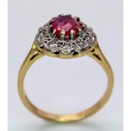 1650 - An 18K Yellow Gold, Burmese Ruby and Diamond Ring. 1ct central oval cut ruby with a diamond surround... 