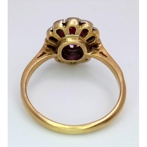 1650 - An 18K Yellow Gold, Burmese Ruby and Diamond Ring. 1ct central oval cut ruby with a diamond surround... 