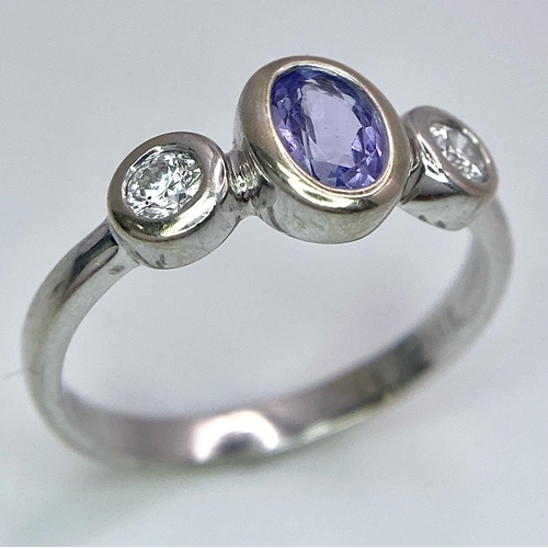 1670 - An 18K White Gold, Tanzanite and Diamond Ring. Size M. 3g total weight.