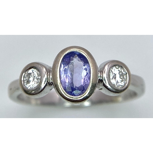 1670 - An 18K White Gold, Tanzanite and Diamond Ring. Size M. 3g total weight.