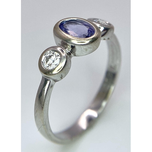 1670 - An 18K White Gold, Tanzanite and Diamond Ring. Size M. 3g total weight.