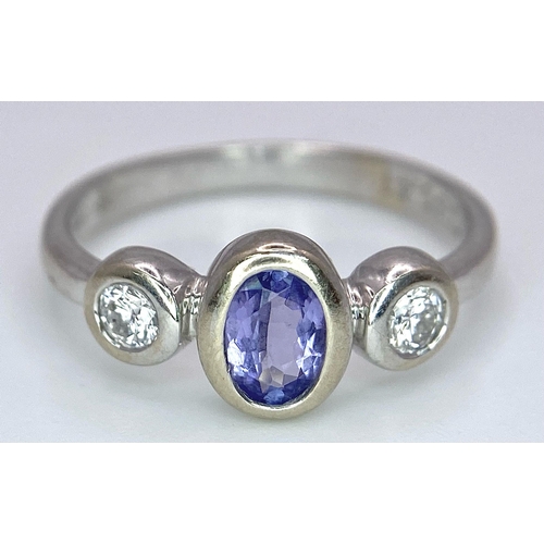 1670 - An 18K White Gold, Tanzanite and Diamond Ring. Size M. 3g total weight.