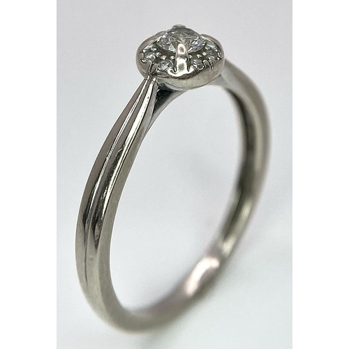 1677 - A 9K White Gold Diamond Ring. Central 0.16ct stone with smaller diamond surround. Size L. 1.86g tota... 