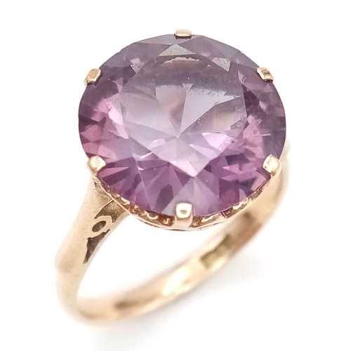 1734 - A 14K ROSE GOLD RING WITH ALEXANDRITE COLOURED STONE .  2.9gms   size N