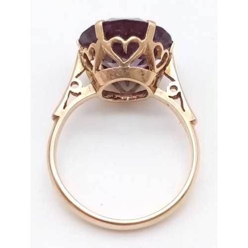 1734 - A 14K ROSE GOLD RING WITH ALEXANDRITE COLOURED STONE .  2.9gms   size N