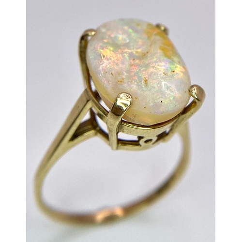 1629 - A 9K Yellow Gold and Australian Opal Ring. Excellent colour play with approx 4ct opal. Size P. 3g to... 