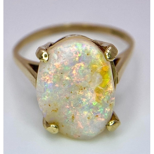 1629 - A 9K Yellow Gold and Australian Opal Ring. Excellent colour play with approx 4ct opal. Size P. 3g to... 