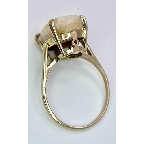 1629 - A 9K Yellow Gold and Australian Opal Ring. Excellent colour play with approx 4ct opal. Size P. 3g to... 