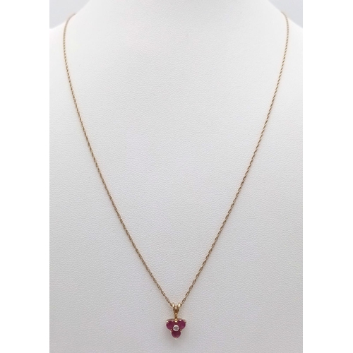 1382 - A fancy 9K yellow gold Ruby and Diamond pendant on gold chain. Total weight 1.4G. Total length 50cm.