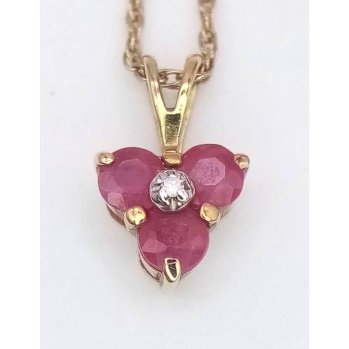 1382 - A fancy 9K yellow gold Ruby and Diamond pendant on gold chain. Total weight 1.4G. Total length 50cm.