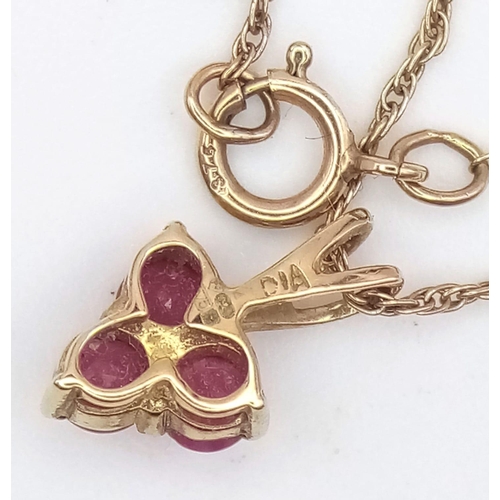 1382 - A fancy 9K yellow gold Ruby and Diamond pendant on gold chain. Total weight 1.4G. Total length 50cm.