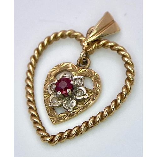 1684 - A 9K Yellow Gold (tested) Diamond and Ruby Heart Pendant. 
3cm. 1.8g total weight.