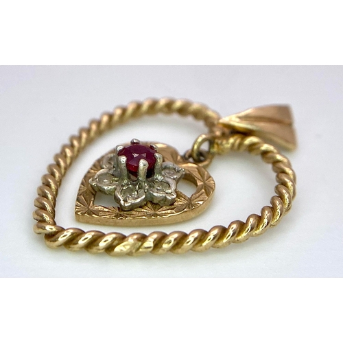 1684 - A 9K Yellow Gold (tested) Diamond and Ruby Heart Pendant. 
3cm. 1.8g total weight.