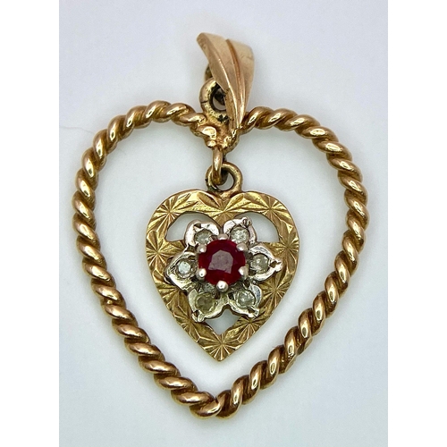 1684 - A 9K Yellow Gold (tested) Diamond and Ruby Heart Pendant. 
3cm. 1.8g total weight.