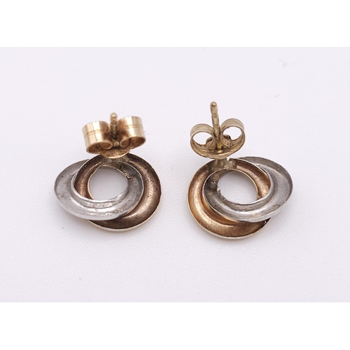 1785 - A Pair of Yellow and White 9K Gold Small Double Spiral Earrings. 0.8g weight.